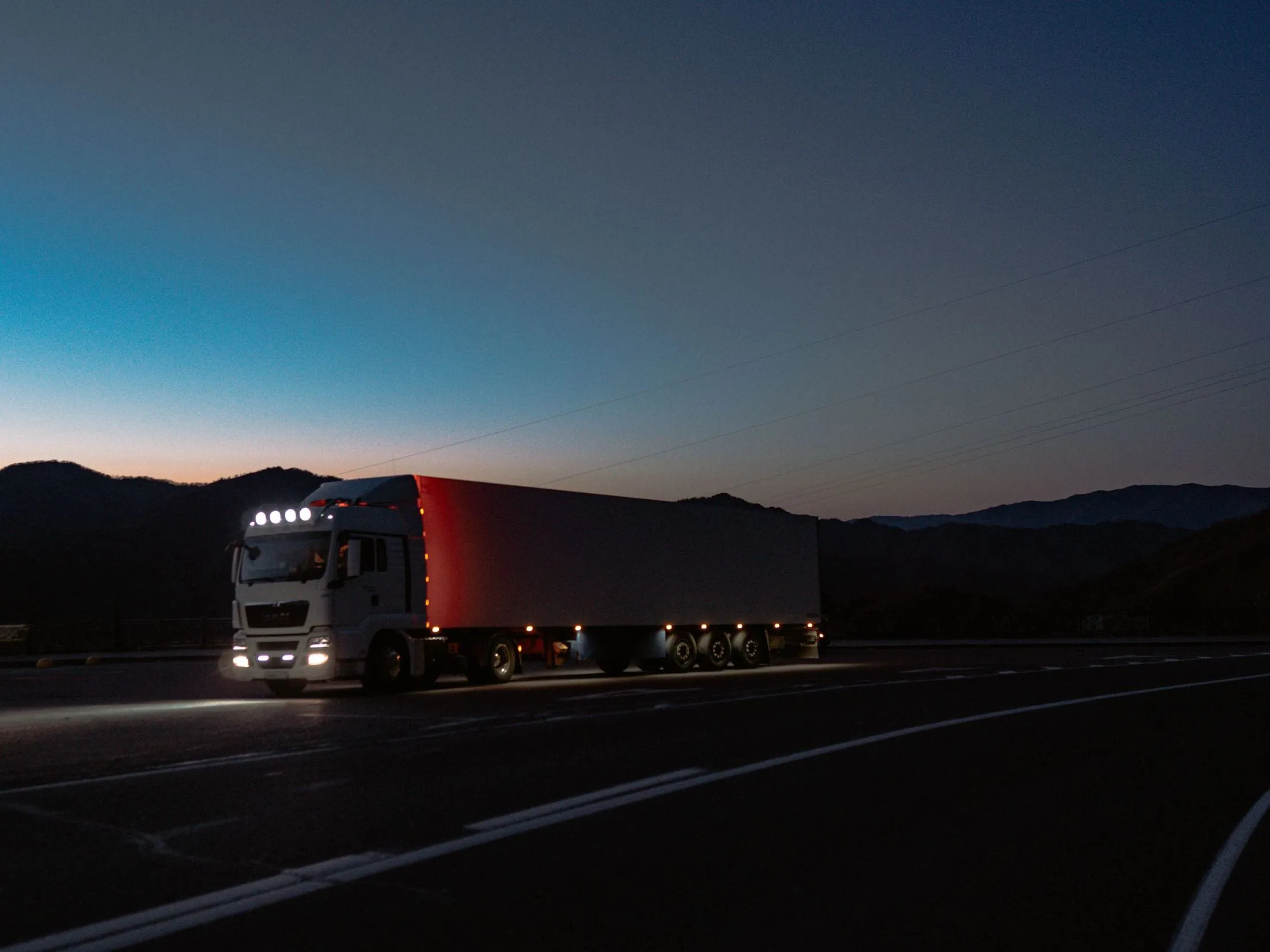 A truck on the road at dusk
