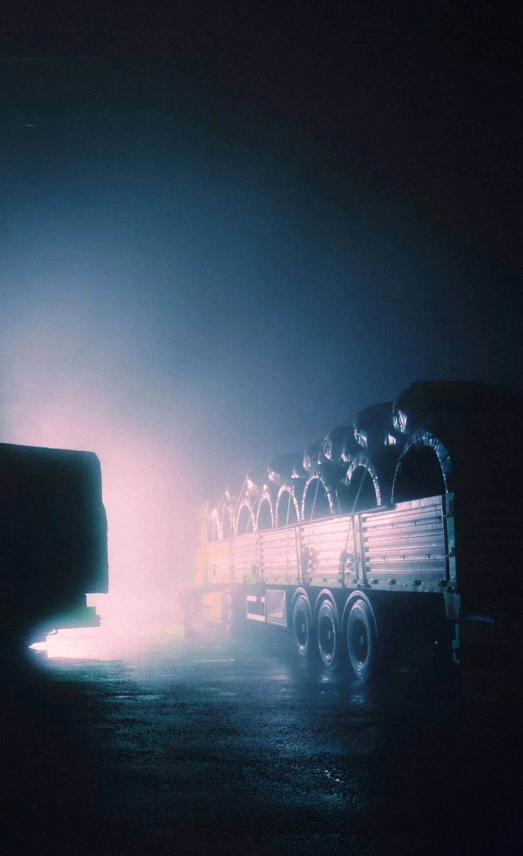Trailers parked at night in fog
